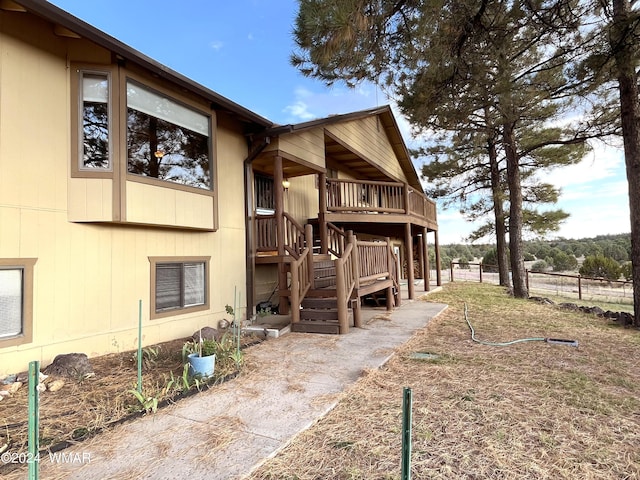 exterior space with fence and a deck