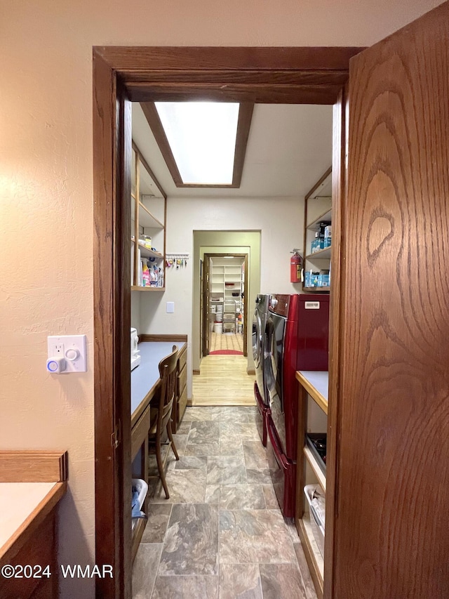 office area featuring stone finish floor and washer and dryer