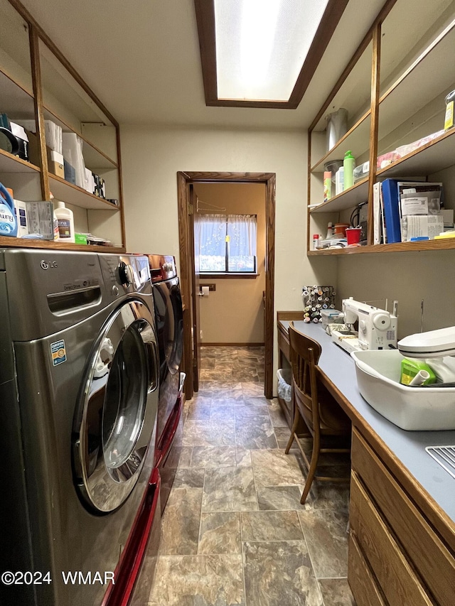 washroom with laundry area, stone finish floor, baseboards, and separate washer and dryer