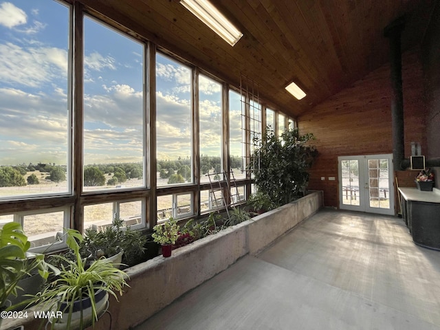 sunroom featuring lofted ceiling, wooden ceiling, and french doors