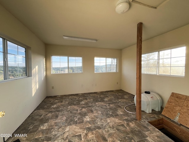 spare room featuring stone finish floor