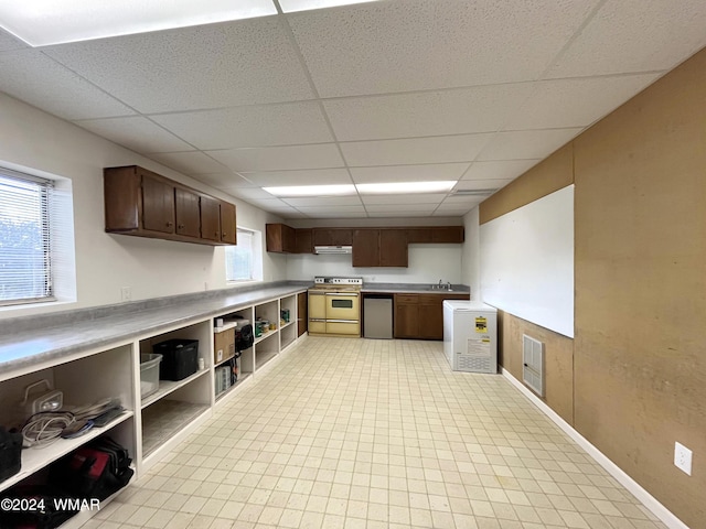 kitchen featuring under cabinet range hood, a sink, visible vents, range, and dishwasher