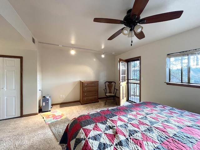 bedroom with ceiling fan, light carpet, visible vents, baseboards, and rail lighting