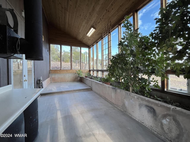 unfurnished sunroom featuring vaulted ceiling and wooden ceiling