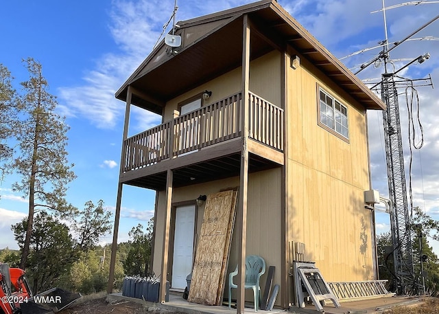 rear view of property with a balcony