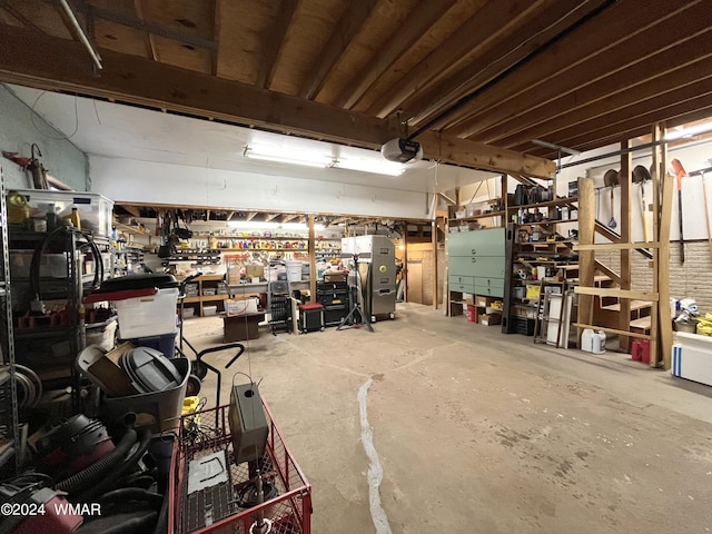 garage featuring a garage door opener and a workshop area