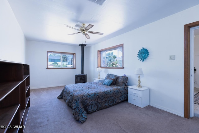 839 S 3rd St, Snowflake, AZ 85937 - bedroom with carpet flooring, multiple windows, a wood stove, and baseboards