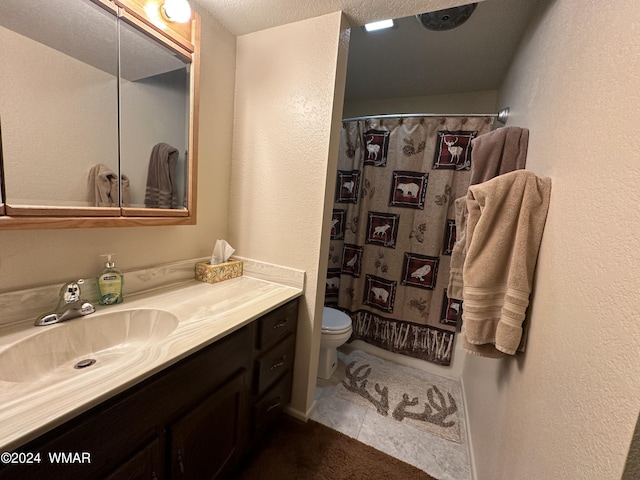 bathroom featuring curtained shower, toilet, vanity, baseboards, and tile patterned floors