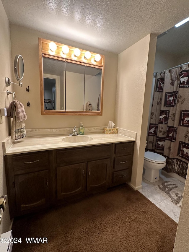 bathroom featuring toilet, tile patterned flooring, a textured ceiling, vanity, and a shower with curtain