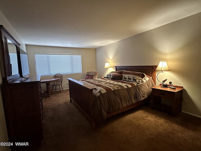 bedroom with dark colored carpet