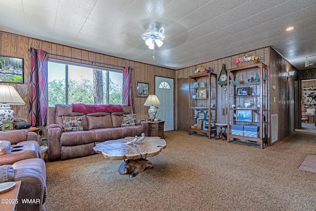 978 Timberland Rd, Show Low, AZ 85901 - carpeted living room featuring wooden walls and a ceiling fan
