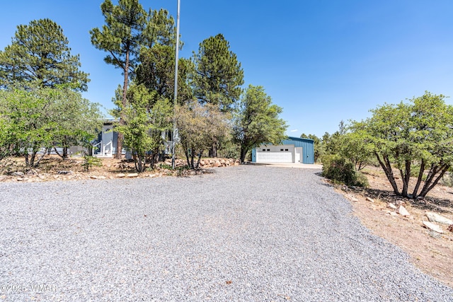 978 Timberland Rd, Show Low, AZ 85901 - view of property hidden behind natural elements with a garage and an outbuilding