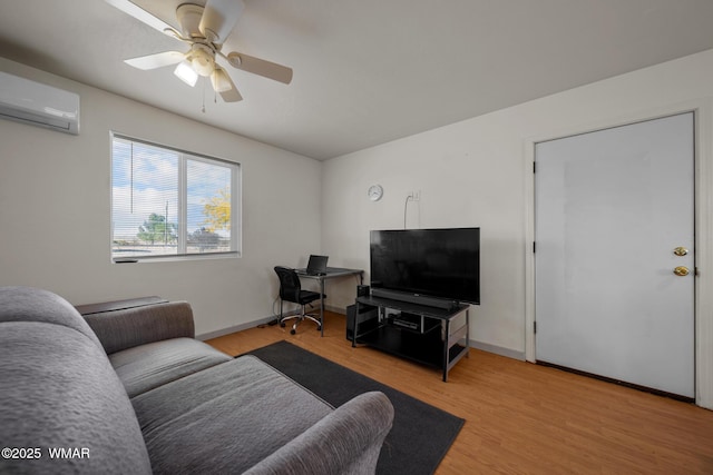 202 700th St W, Taylor, AZ 85939 - living room featuring a wall mounted air conditioner, light wood-style flooring, baseboards, and ceiling fan