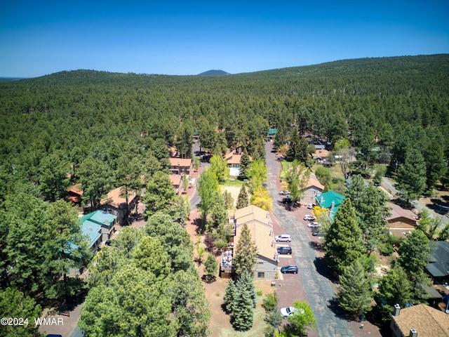 drone / aerial view featuring a wooded view