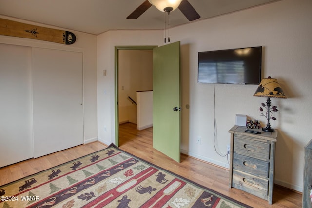 bedroom with baseboards, a closet, a ceiling fan, and light wood-style floors