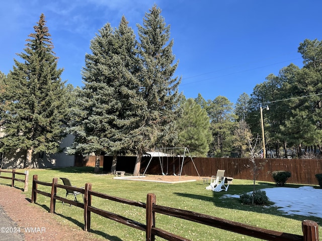 view of yard with a playground and fence