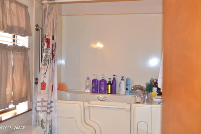 bathroom with toilet, a shower with curtain, and washer / dryer
