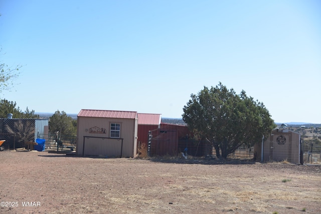 view of pole building featuring fence