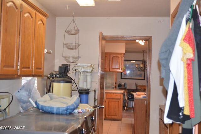 kitchen with light countertops, light tile patterned flooring, and brown cabinetry