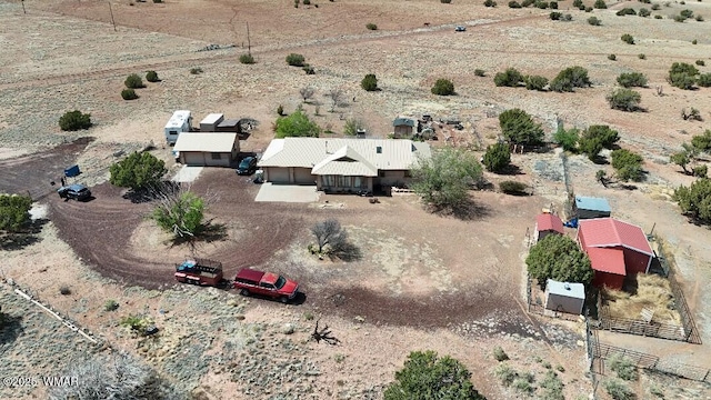 birds eye view of property featuring a rural view and a desert view