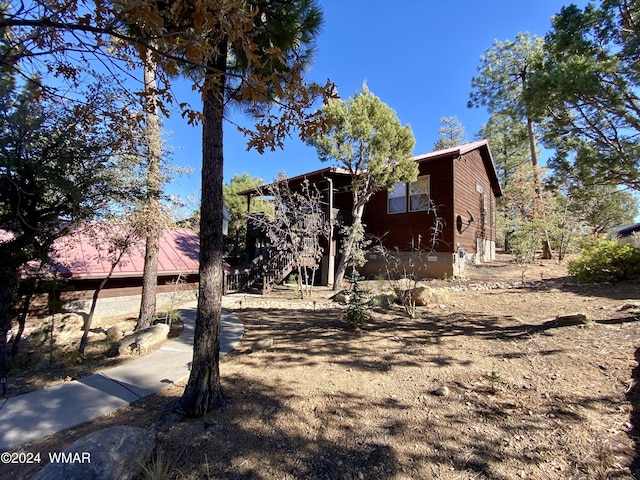 view of side of home featuring stairway