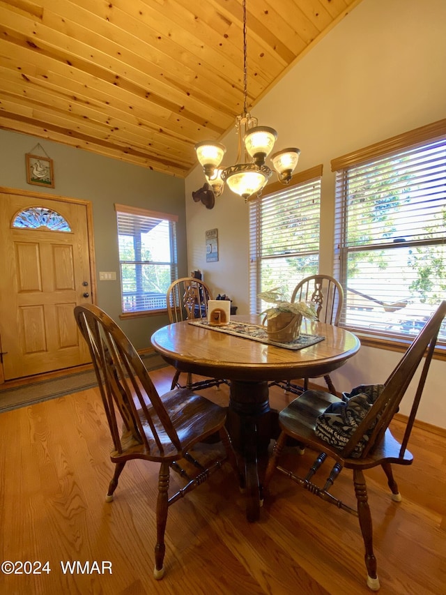 dining room featuring vaulted ceiling, wood ceiling, light wood-style flooring, and an inviting chandelier