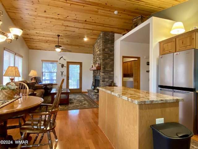 kitchen with light wood-type flooring, wooden ceiling, open floor plan, and freestanding refrigerator