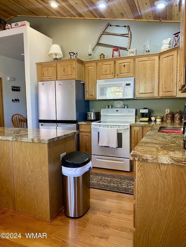 kitchen with wooden ceiling, white appliances, a sink, light wood-style floors, and vaulted ceiling