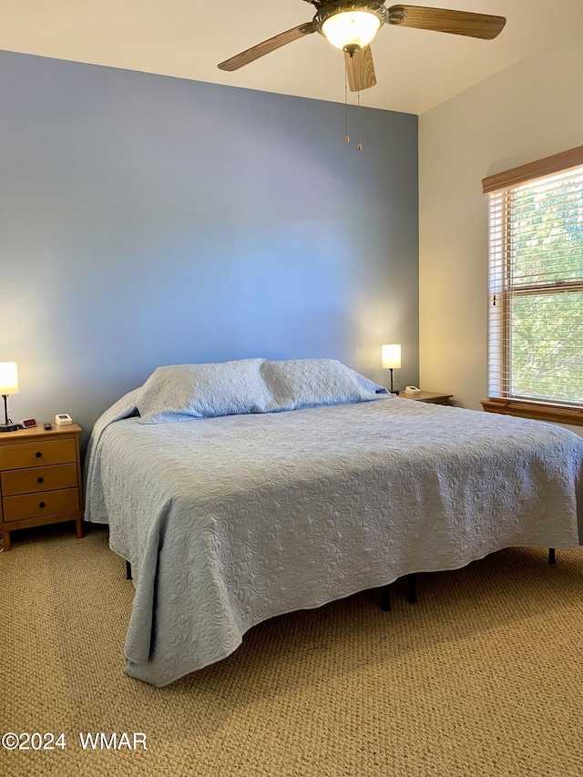 bedroom featuring ceiling fan and light colored carpet