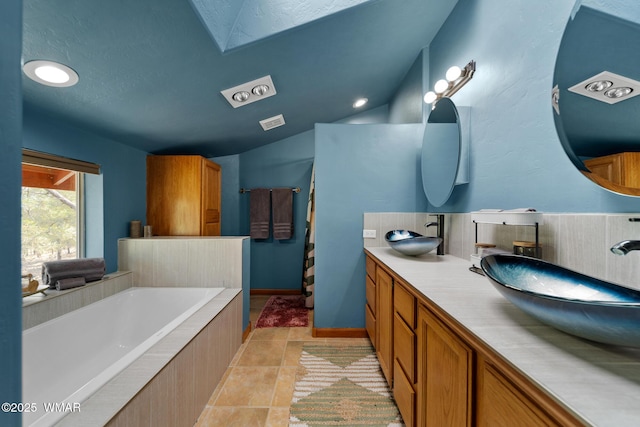 746 Jacks Wild Rd, Show Low, AZ 85901 - bathroom featuring visible vents, a sink, a bath, and double vanity