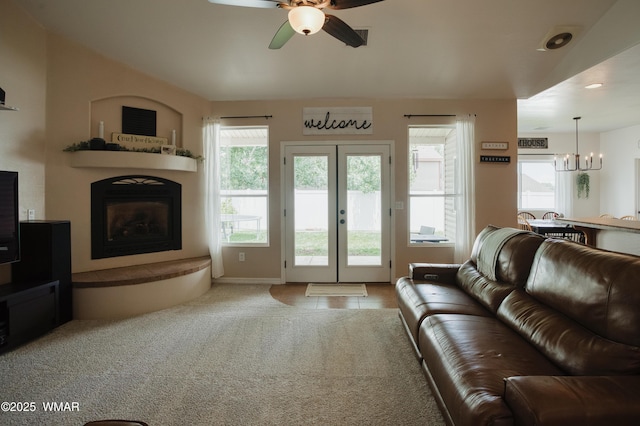 545 S 7th St, Snowflake, AZ 85937 - living room with ceiling fan, a fireplace with raised hearth, a chandelier, french doors, and carpet flooring
