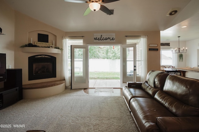 545 S 7th St, Snowflake, AZ 85937 - living room featuring a fireplace with raised hearth, ceiling fan, healthy amount of natural light, a chandelier, and recessed lighting