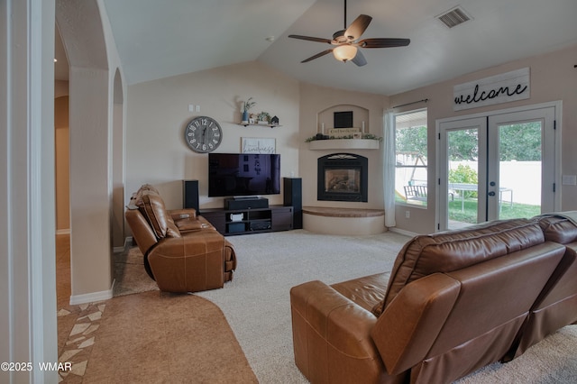 545 S 7th St, Snowflake, AZ 85937 - carpeted living area featuring lofted ceiling, a ceiling fan, a glass covered fireplace, arched walkways, and french doors