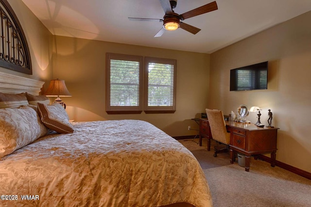 carpeted bedroom with a ceiling fan and baseboards