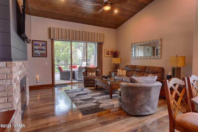 living room featuring wood finished floors, a ceiling fan, wood ceiling, baseboards, and a brick fireplace