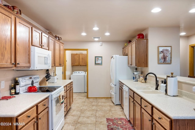 kitchen featuring recessed lighting, white appliances, a sink, light countertops, and washer / dryer