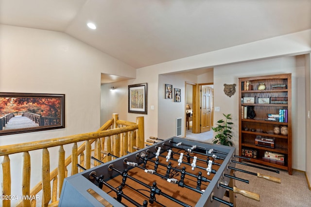 recreation room featuring carpet floors and vaulted ceiling