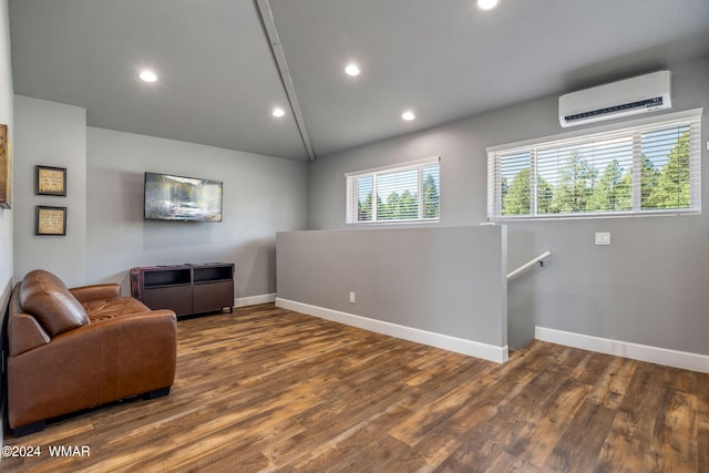 living area featuring dark wood-style floors, recessed lighting, an AC wall unit, an upstairs landing, and baseboards