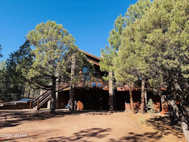 exterior space with stairway and a deck