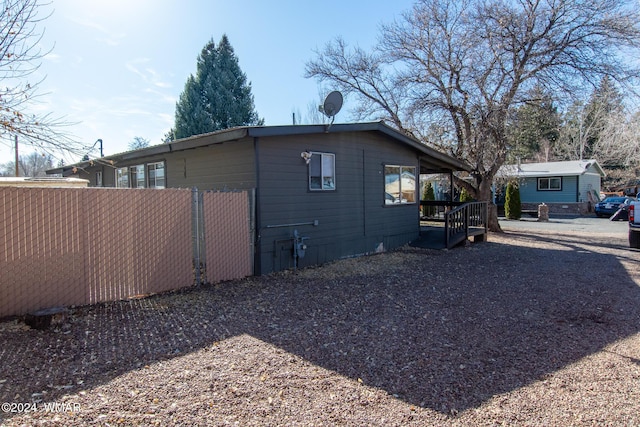 view of side of property featuring fence