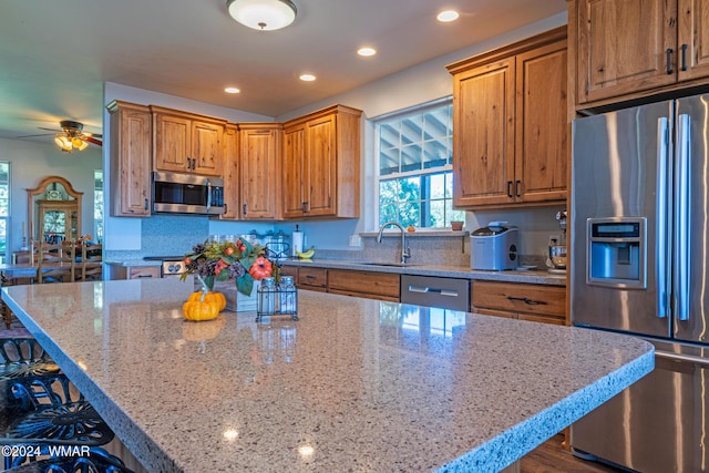 kitchen with a kitchen island, appliances with stainless steel finishes, and a breakfast bar area