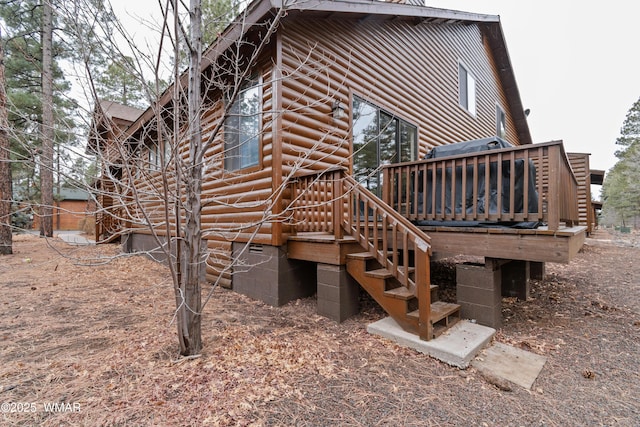 view of property exterior featuring crawl space, stairway, and a wooden deck