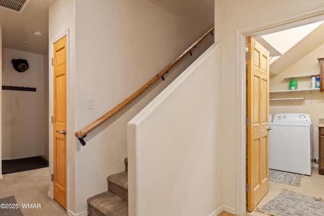 stairs featuring washer / dryer, lofted ceiling, and visible vents