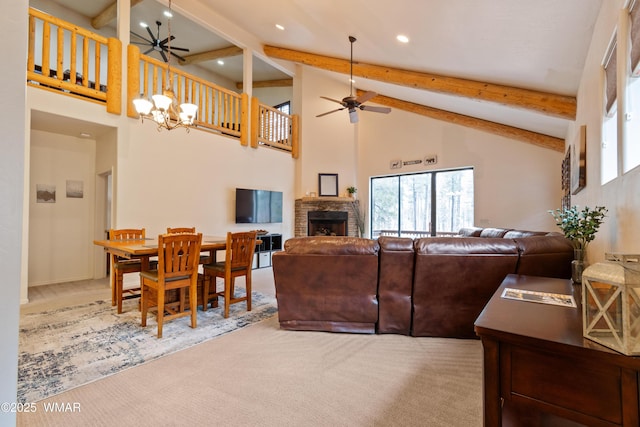 carpeted living room featuring high vaulted ceiling, beam ceiling, a fireplace, and ceiling fan