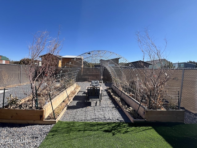 view of yard featuring a vegetable garden and fence