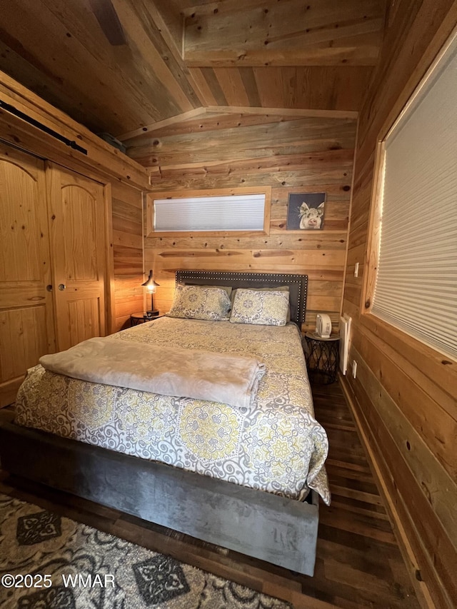 bedroom with vaulted ceiling with beams, dark wood-style floors, wood ceiling, and wooden walls