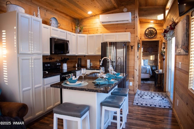 kitchen with electric range, wooden walls, wooden ceiling, an AC wall unit, and a sink