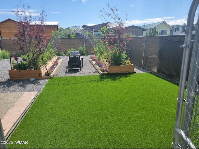 view of yard with a garden and fence