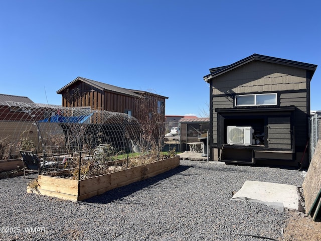 exterior space with ac unit and a garden