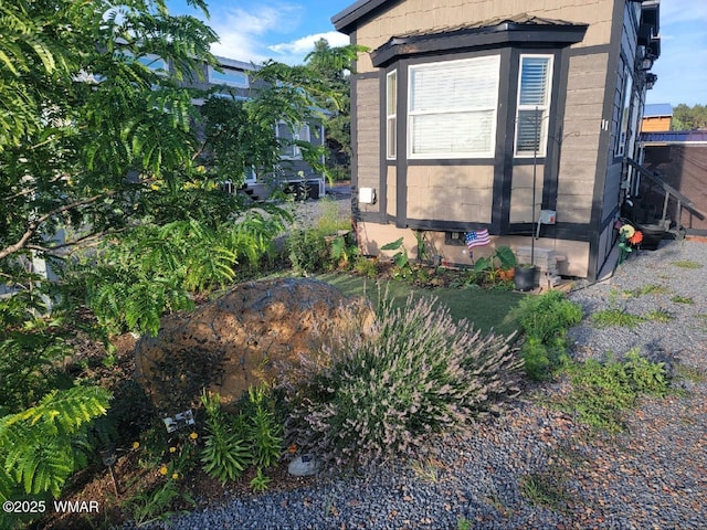 view of home's exterior with entry steps and concrete block siding